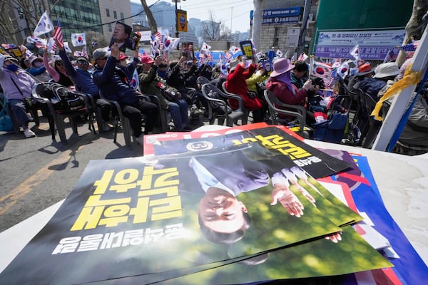 Supporters of impeached South Korean President Yoon Suk Yeol stage a rally to oppose his impeachment near the Constitutional Court in Seoul, South Korea, Tuesday, April 1, 2025. The letters read "Dismiss impeachment." (AP Photo/Ahn Young-joon)