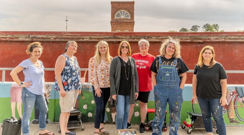 Cherokee High School teacher Shanna Coulter (second from right) was the lead artist on the Canton mural. Brooke Schmidt, Canton City Councilor (Ward 3) (center) helped coordinate along with several other volunteers. Photo by Bronson Kurtz