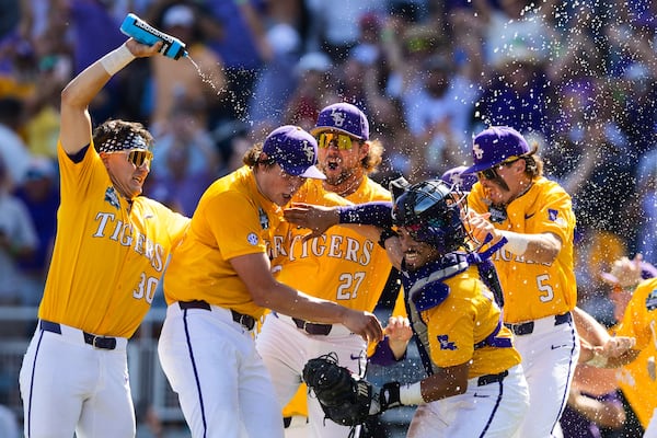 LSU players celebrate their 5-3 win over Coastal Carolina in Game 2 of the NCAA College World Series baseball finals in Omaha, Neb., Sunday, June 22, 2025. (AP Photo/Rebecca S. Gratz)