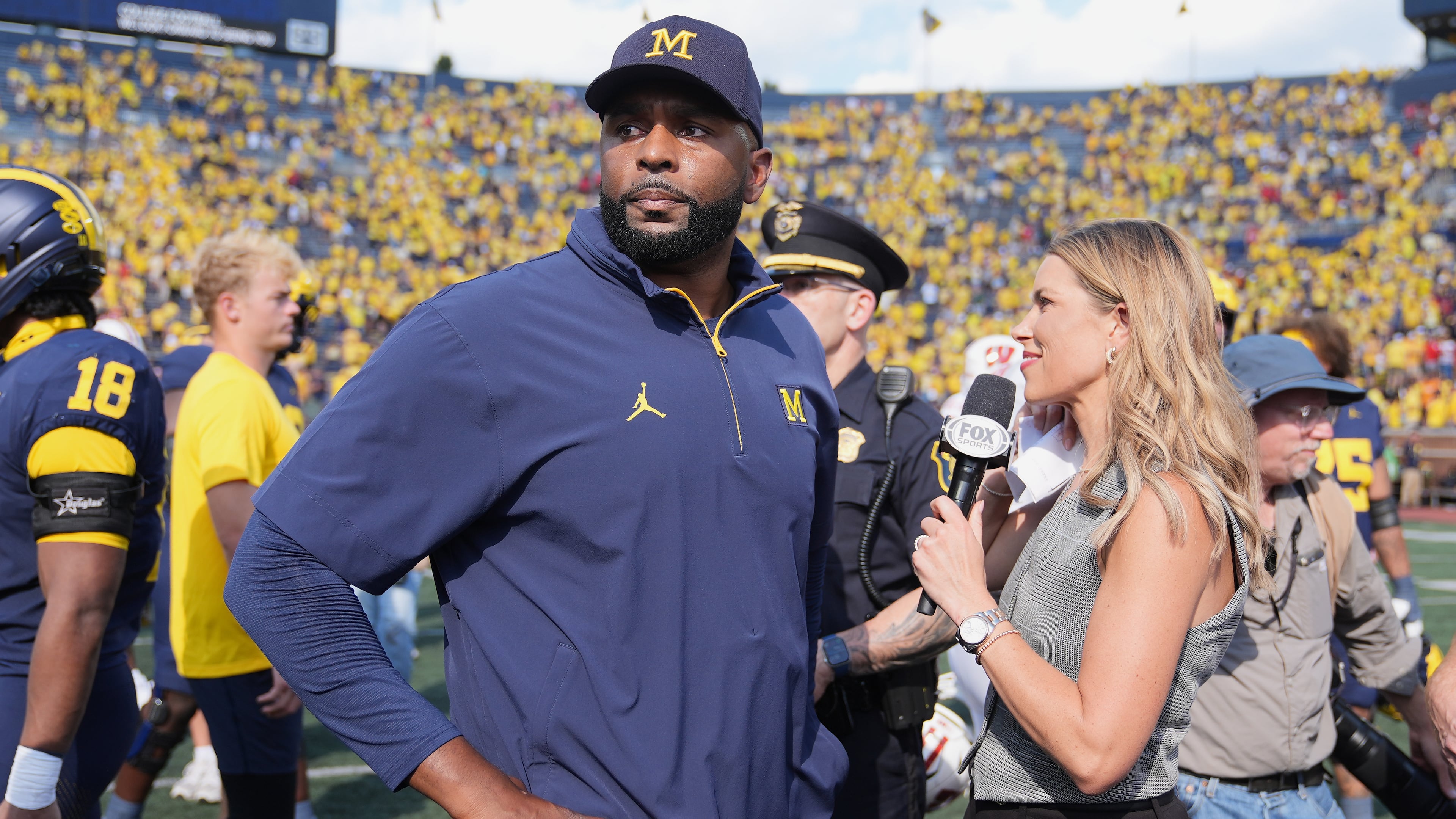 Michigan head coach Sherrone Moore gives a news interview after the team's win in an NCAA college football game against Wisconsin, Saturday, Oct. 4, 2025, in Ann Arbor, Mich. (AP Photo/Ryan Sun)