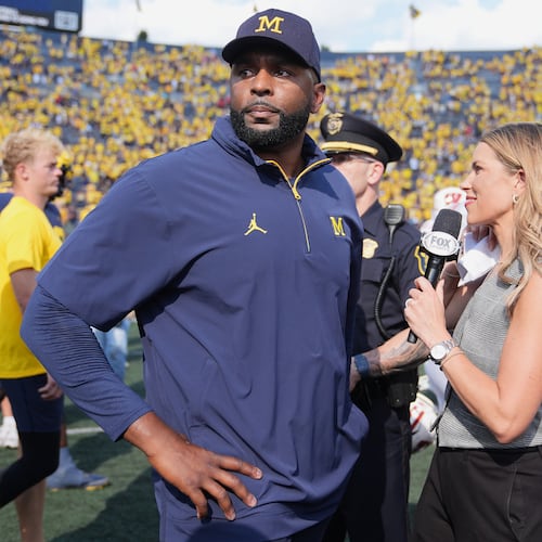 Michigan head coach Sherrone Moore gives a news interview after the team's win in an NCAA college football game against Wisconsin, Saturday, Oct. 4, 2025, in Ann Arbor, Mich. (AP Photo/Ryan Sun)