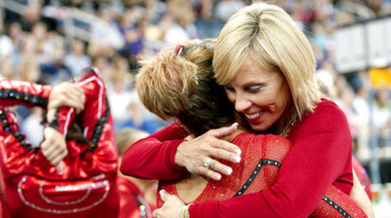 UGA's head Suzanne Yoculan (right) encourages Cassidy McComb half way through the competition.