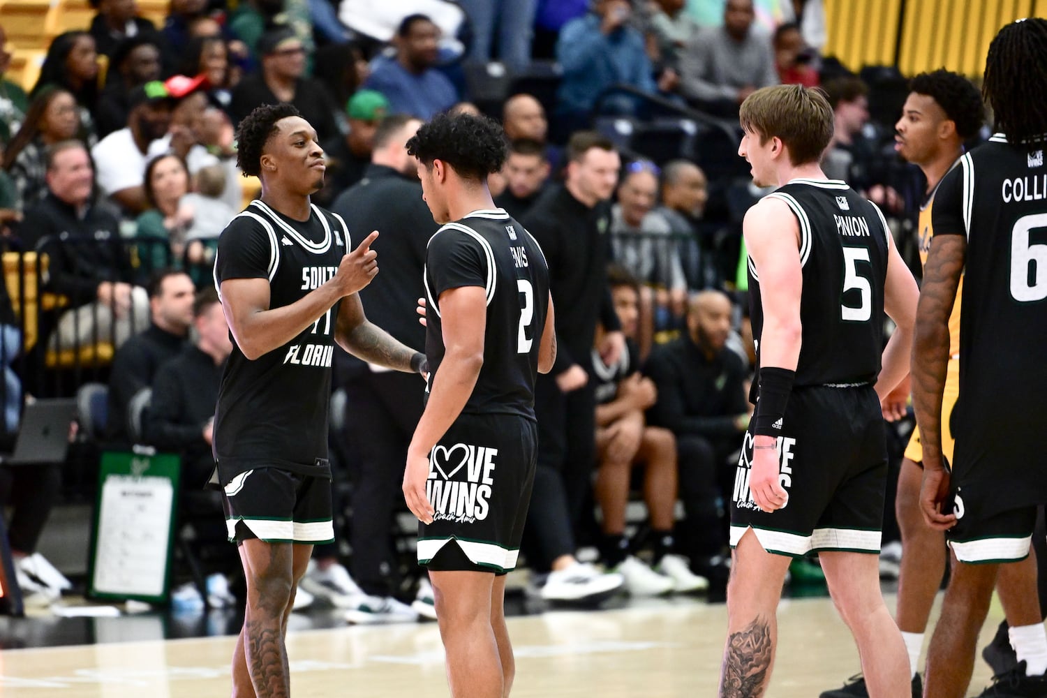 The South Florida Bulls celebrate their 108-89 win over the Owls Sunday, Nov. 16, 2025 at Kennesaw State University. (Daniel Varnado for the AJC)