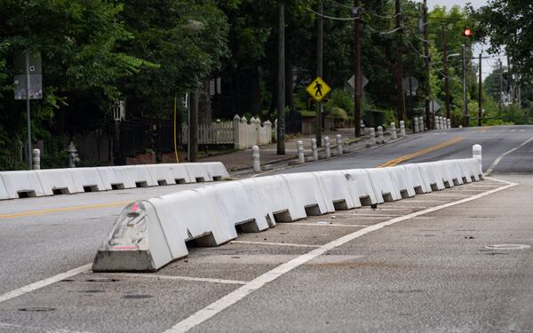 In the two months since these barriers were swapped in on Cherokee Avenue, vehicles have crashed into them at least three times. (Ben Hendren for the AJC)