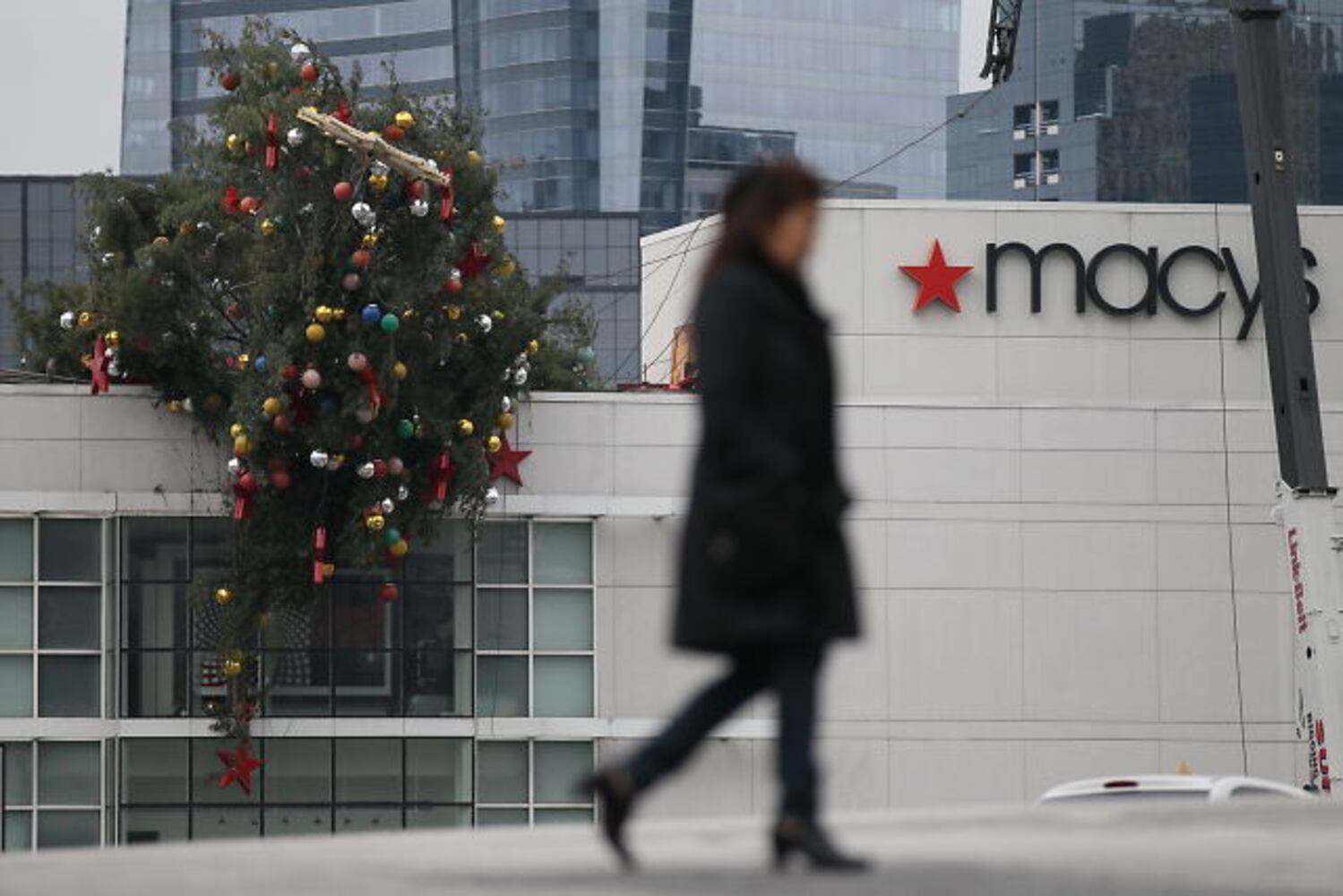 Crane buckles, leaving Christmas tree hanging off roof