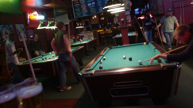 Patrons play pool at Famous Pub. / AJC file photo
