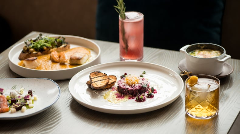 Tin Tin Steak Tartare, Aix Bouillabaisse, Salmon Mi Cuit, Apple and Camembert Gratin. Photo credit- Mia Yakel.
