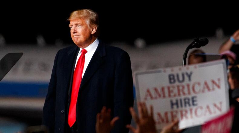 President Donald Trump looks to the cheering audience as he leaves a campaign rally at Minuteman Aviation Hangar, Thursday, Oct. 18, 2018, in Missoula, Montana. (AP Photo/Carolyn Kaster)