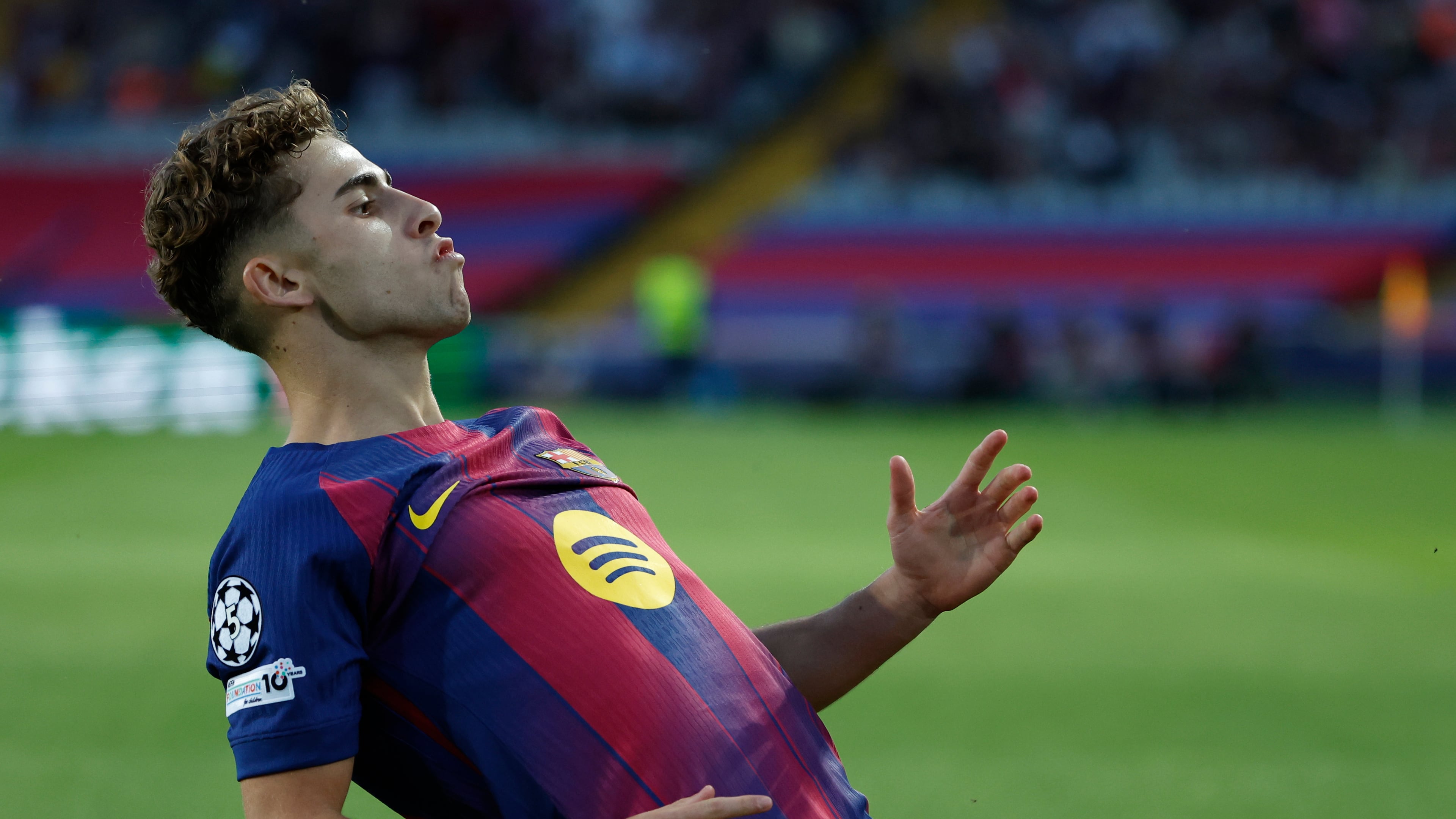 Barcelona's Fermin Lopez celebrates after scoring the opening goal of his team during the Champions League opening phase soccer match between Barcelona and Olympiacos in Barcelona, Spain, Tuesday, Oct. 21, 2025. (AP Photo/Joan Monfort)