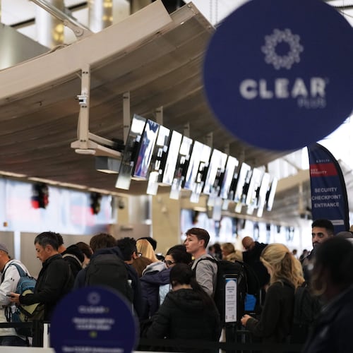 Travelers wait in a TSA checkpoint at Detroit Metropolitan Wayne County Airport Wednesday, Nov. 26, 2025, in Romulus, Mich. (AP Photo/Ryan Sun)