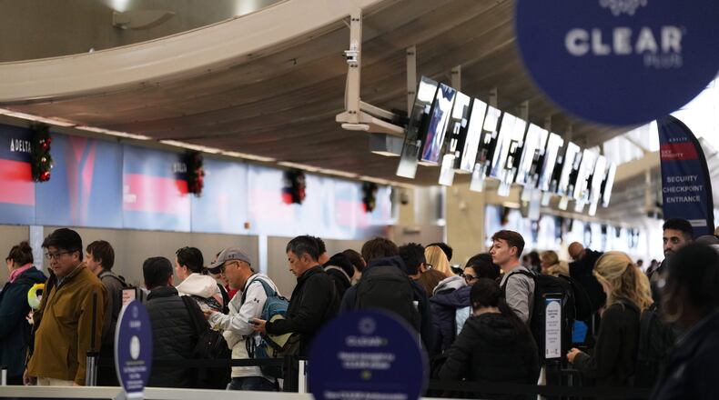 Travelers wait in a TSA checkpoint at Detroit Metropolitan Wayne County Airport Wednesday, Nov. 26, 2025, in Romulus, Mich. (AP Photo/Ryan Sun)