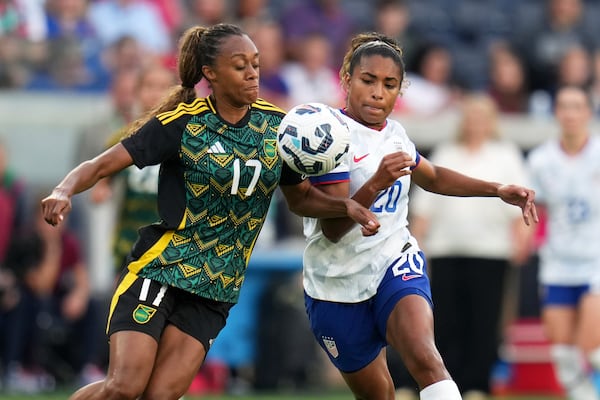 Jamaica's Allyson Swaby (17) and United States' Catarina Macario (20) battle for the ball during the first half of an international friendly soccer match Tuesday, June 3, 2025, in St. Louis. (AP Photo/Jeff Roberson)