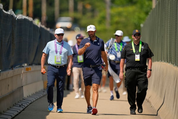 Dustin Johnson uses a pedestrian bridge over the Pennsylvania Turnpike, which divides Oakmont Country Club, during a practice round ahead of the U.S. Open golf tournament Wednesday, June 11, 2025, in Oakmont, Pa. (AP Photo/Carolyn Kaster)