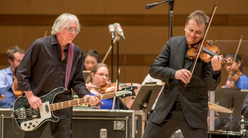 Mike Mills (left) and Robert McDuffie perform Mill's concerto.