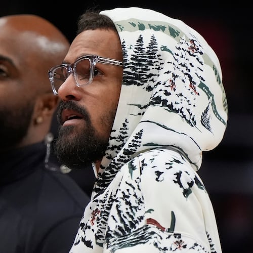 Injured Hawks guard Trae Young walks on the court during a break against the Los Angeles Clippers on Wednesday, Dec. 3, 2025, in Atlanta. The Hawks have not given a firm date on Young’s return to play. (Mike Stewart/AP)