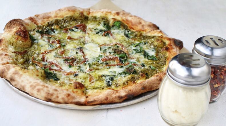 Genuine Pizza’s kale pie is made with caramelized onion, chile flakes, and fontina and Parmesan cheeses. CONTRIBUTED BY GENUINE PIZZA