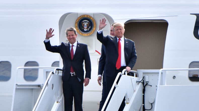 November 4, 2018 Macon - GOP gubernatorial candidate Brian Kemp and President Donald Trump wave from Air Force One as President Donald J. Trump arrives during President Donald J. Trump's Make America Great Again Rally to support Brian Kemp at Middle Georgia Regional Airport in MaconSunday, November 4, 2018. HYOSUB SHIN / HSHIN@AJC.COM