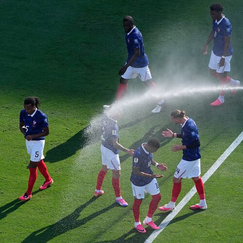French players cool off from field sprinklers during the World Cup round of 32 soccer match against Sweden in East Rutherford, N.J., near New York, Tuesday, June 30, 2026. (AP Photo/Petr David Josek)
