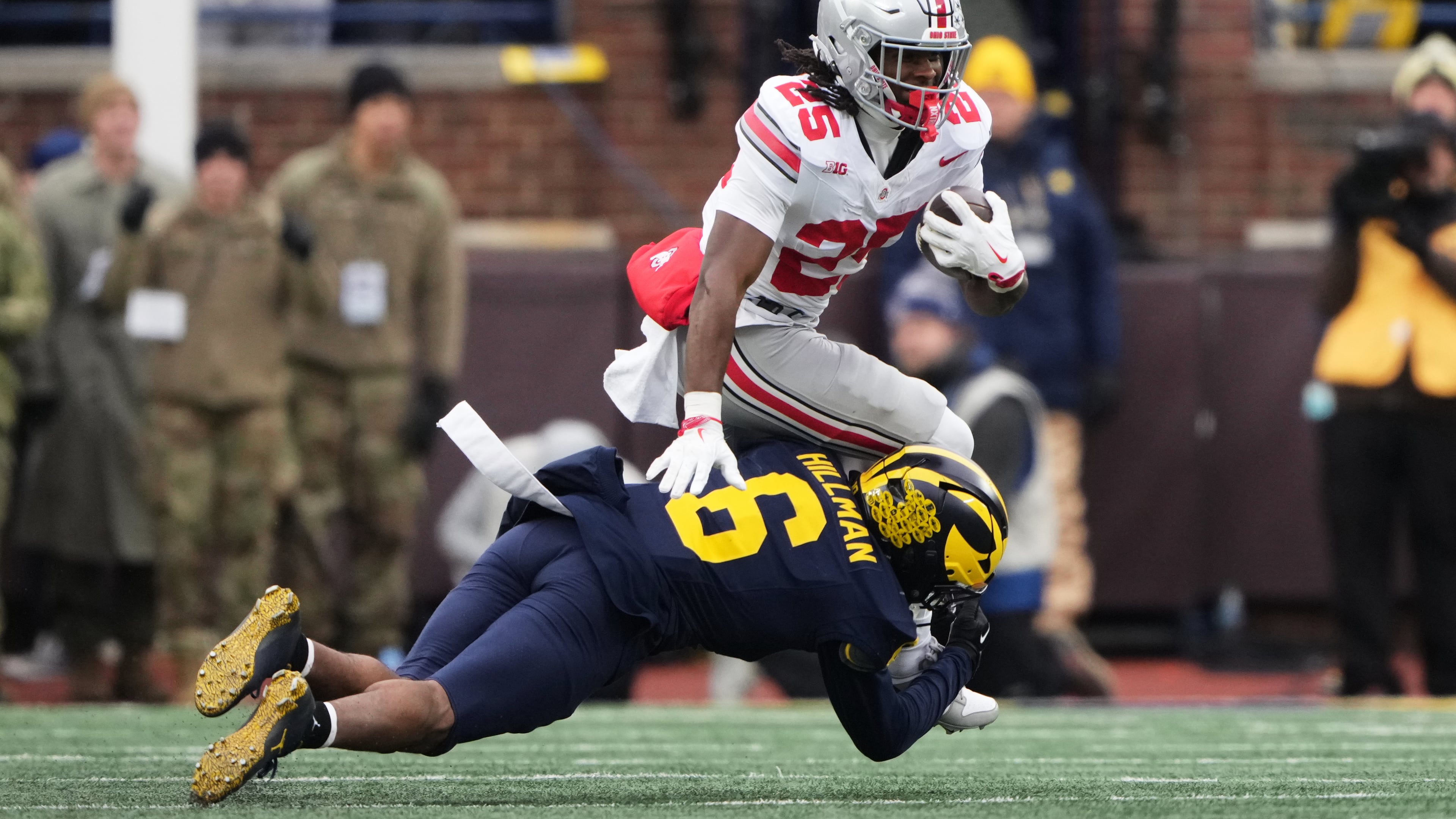Ohio State running back Bo Jackson, top, is tackled by Michigan defensive back Brandyn Hillman during the first half of an NCAA college football game, Saturday, Nov. 29, 2025, in Ann Arbor, Mich. (AP Photo/Ryan Sun)