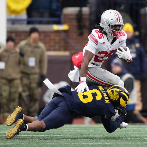 Ohio State running back Bo Jackson, top, is tackled by Michigan defensive back Brandyn Hillman during the first half of an NCAA college football game, Saturday, Nov. 29, 2025, in Ann Arbor, Mich. (AP Photo/Ryan Sun)