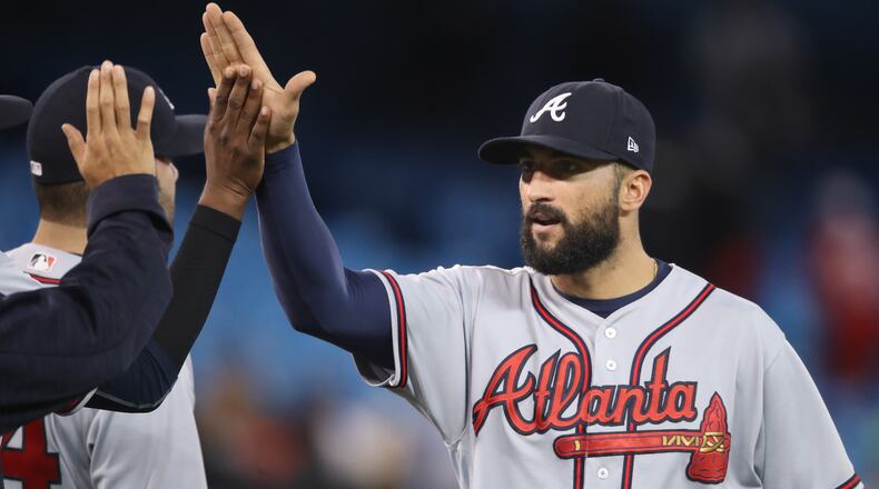 Nick Markakis of the Atlanta Braves celebrates their victory with teammates during MLB game action against the Toronto Blue Jays at Rogers Centre on May 15, 2017 in Toronto, Canada. (Photo by Tom Szczerbowski/Getty Images)