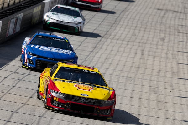 Joey Logano (22) goes into Turn 3 as Kyle Larson (5) prepares to lap him during a NASCAR Cup Series auto race, Sunday, April 13, 2025, in Bristol, Tenn. (AP Photo/Wade Payne)