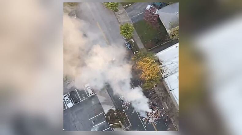 Huge plumes of smoke hover over the flaming pile of garbage in northeast Atlanta's Virginia-Highland neighborhood.