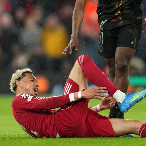 Liverpool's Hugo Ekitike reacts after getting injured during the Champions League quarterfinal second leg soccer match between Liverpool and Paris Saint-Germain in Liverpool, England, Tuesday, April 14, 2026. (AP Photo/Jon Super)