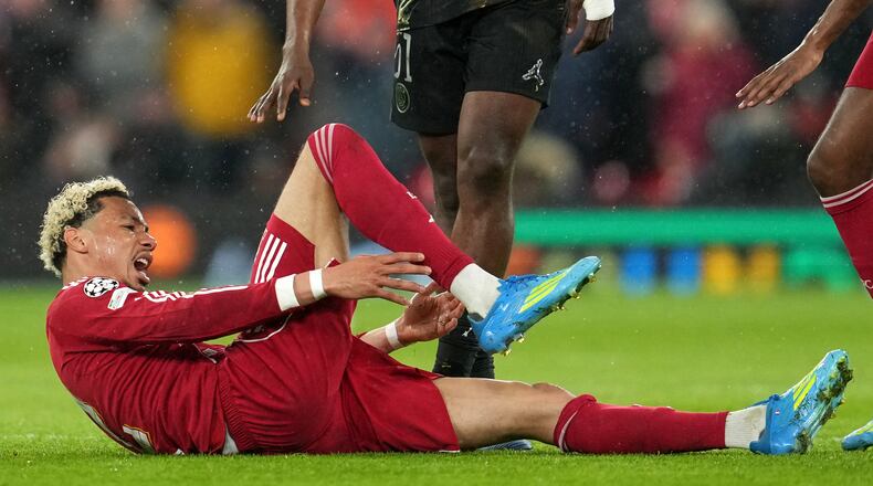 Liverpool's Hugo Ekitike reacts after getting injured during the Champions League quarterfinal second leg soccer match between Liverpool and Paris Saint-Germain in Liverpool, England, Tuesday, April 14, 2026. (AP Photo/Jon Super)