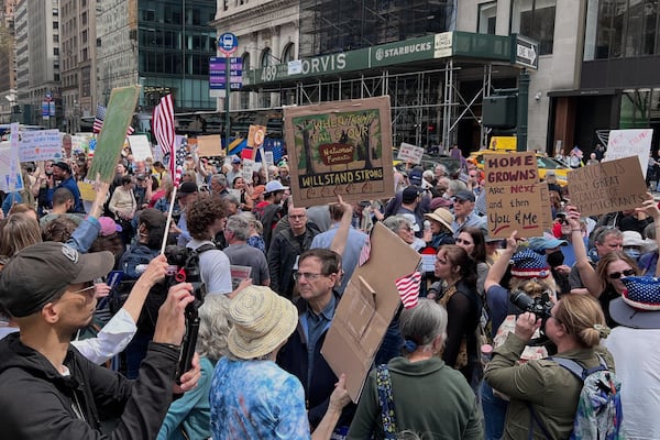 People gather to protest President Donald Trump's policies on Saturday, April 19, 2025 in New York. (AP Photo/Joseph Frederick)