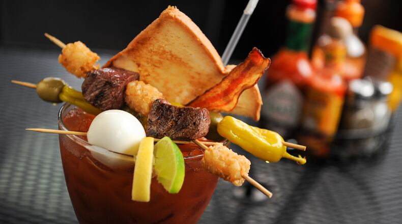 The Bloody Best - A 32 oz glass with 6 ounces of Absolute Peppar Vodka mixed with spicy Bloody Mary mix, topped with pepperoncinis, blue cheese stuffed olives, tots, steak, a slice of toast, bacon and a hard boiled egg and a beef straw at The Nook. (BECKYSTEINPHOTOGRAPHY.COM)