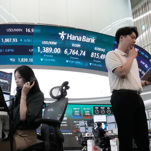 Currency traders work at the foreign exchange dealing room of the Hana Bank headquarters in Seoul, South Korea, Friday, Aug. 21, 2026. (AP Photo/Ahn Young-joon)