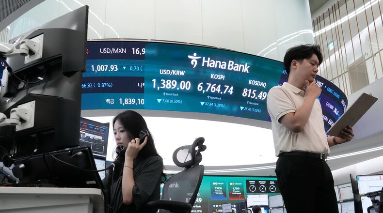 Currency traders work at the foreign exchange dealing room of the Hana Bank headquarters in Seoul, South Korea, Friday, Aug. 21, 2026. (AP Photo/Ahn Young-joon)