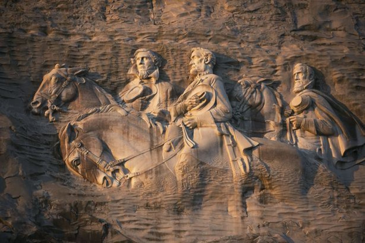 From left to right: Jeff Davis, Robert E. Lee and Stonewall Jackson carved into the side of Stone Mountain. (AJC File)
