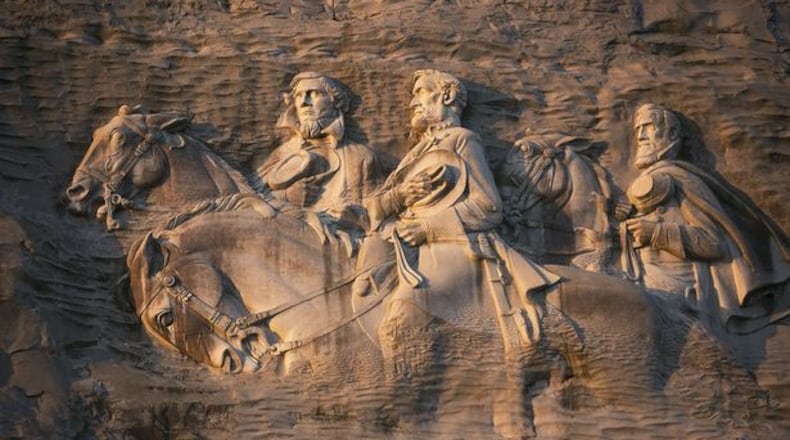From left to right: Jeff Davis, Robert E. Lee and Stonewall Jackson carved into the side of Stone Mountain. (AJC File)