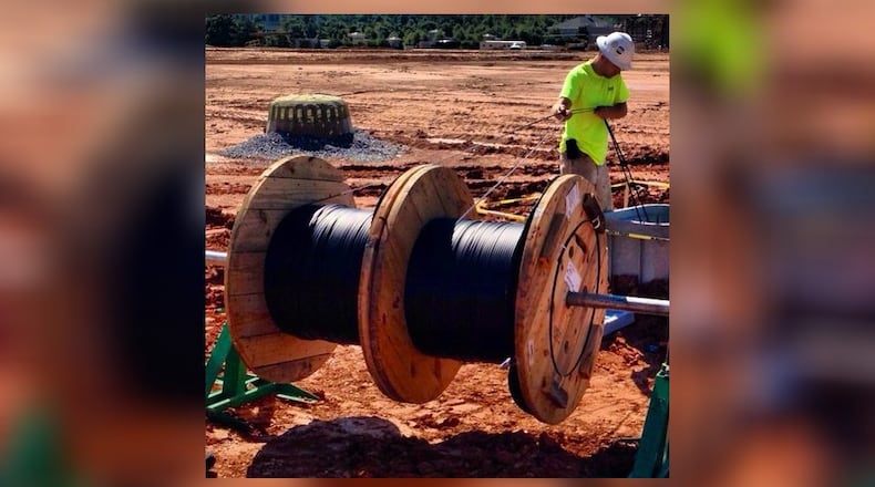 Workers at Avalon, a massive mixed-use development in Alpharetta, recently laid fiber optic cable that will connect every residence, retail shop, office space and hotel with “gigabit” Internet service that is many times faster than traditional broadband service.