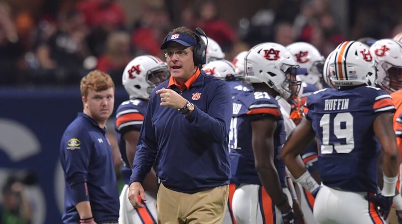 December 2, 2017 Atlanta: Auburn Tigers head coach Gus Malzahn takes a time out with his team during the second half of the SEC Football Championship at Mercedes-Benz Stadium, December 2, 2017, in Atlanta. Hyosub Shin / hshin@ajc.com