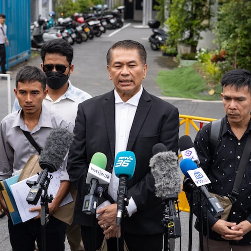 Lawyer Kunpat Singhathong and three sailors from the Thailand-flagged ship, the Mayuree Naree, speak to journalists outside the Central Labour Court in Bangkok, Thailand on Friday, July 10, 2026. (AP Photo/Anton L. Delgado)