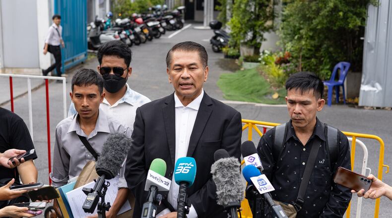 Lawyer Kunpat Singhathong and three sailors from the Thailand-flagged ship, the Mayuree Naree, speak to journalists outside the Central Labour Court in Bangkok, Thailand on Friday, July 10, 2026. (AP Photo/Anton L. Delgado)