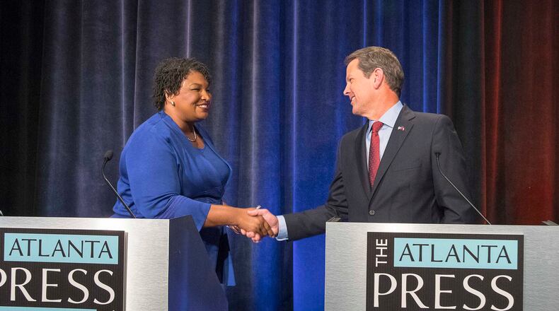 Democrat Stacey Abrams and Republican Brian Kemp greet each other before a 2018 debate, the first time the two ran against each other for governor. Abrams' campaign has been the subject of an investigation by the state ethics commission for 4 years over whether it illegally colluded with groups backing Abrams in that heated contest. (Alyssa Pointer/The Atlanta Journal-Constitution/TNS)