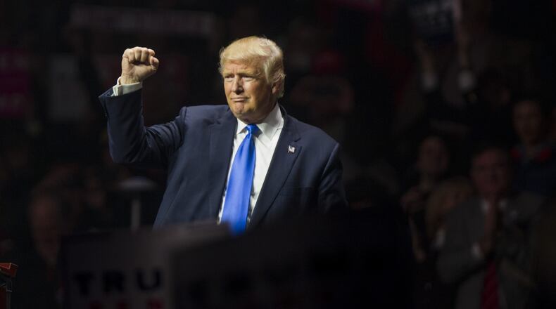 Republican presidential candidate Donald Trump makes a fist at the end of his rally at the SNHU Arena on November 7, 2016 in Manchester, N.H.