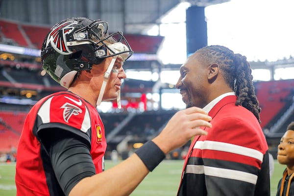 Falcons quarterback Matt Ryan speaks with wide receiver Roddy White before his 2019 induction into the team's Ring of Honor.