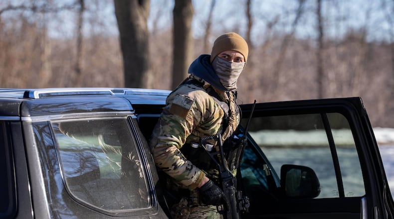 A U.S. Border Patrol officer steps out of his vehicle after blocking a street in Minneapolis, Minn., last month. (Adam Gray/AP)