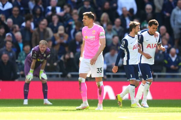 Southampton goalkeeper Aaron Ramsdale, background left and Jan Bednarek foreground react after Tottenham Hotspur's Brennan Johnson, right, scored his side's second goal of the game as he celebrates with teammate James Maddison, during the English Premier League soccer match between Tottenham Hotspur and Southampton at Tottenham Hotspur Stadium, in London, Sunday April 6, 2025. (Bradley Collyer/PA via AP)
