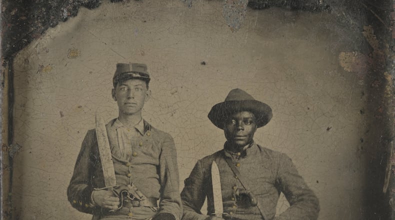 Sergeant A.M. Chandler of the 44th Mississippi Infantry Regiment, Co. F., and Silas Chandler, family slave, with Bowie knives, revolvers, pepper-box, shotgun, and canteen. Photograph shows identified Confederate soldier, A.M. Chandler, and identified slave, Silas Chandler, who accompanied two Chandler brothers during their military service in the Civil War. For more information, see “Glimpses of Soldiers’ Lives,” http://www.loc.gov/rr/print/coll/SoldierbiosChandler.html (Library of Congress)