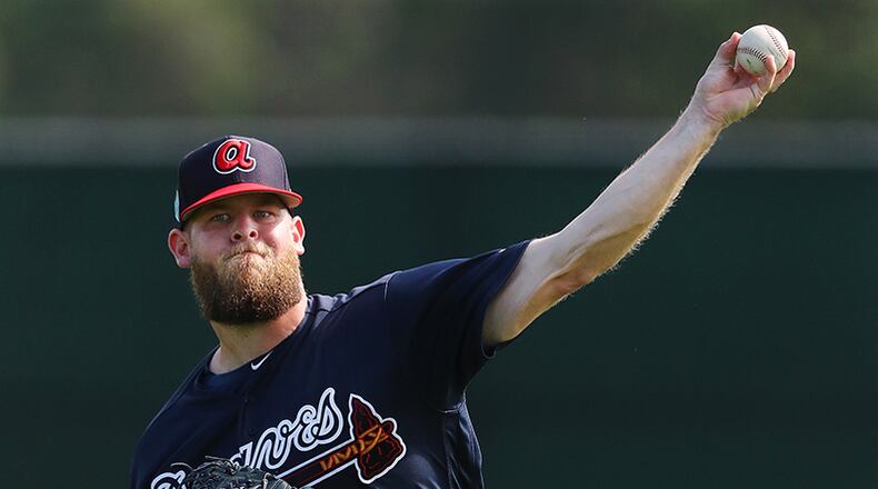 Atlanta Braves pitcher A.J. Minter loosens up his arm throwing in the field during spring training Tuesday, Feb. 19, 2019, at the ESPN Wide World of Sports Complex in Lake Buena Vista, Fla.