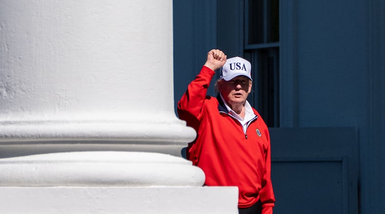 President Donald Trump pumps his fist as he arrives at the White House, Sunday, May 31, 2026, in Washington. (AP Photo/Alex Brandon)
