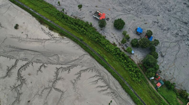 A drone view shows a major section of Pasang Lhamu highway washed away along swollen Trishuli river by recent flash floods cutting off Rasuwa district from Nuwakot area, Nepal, Monday, Aug. 31, 2026. (AP Photo/Rajesh Kumar Singh)