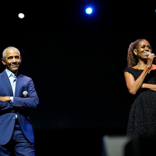 Former President Barack Obama and former first lady Michelle Obama on stage as they surprised administration and campaign alumni in Chicago at the ahead of the dedication ceremony of the Obama Presidential Center, Wednesday, June 17, 2026. (AP Photo/Pablo Martinez Monsivais, Pool)