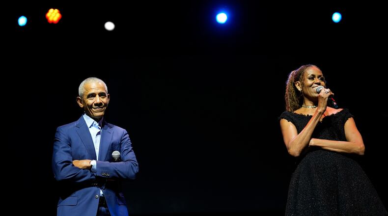 Former President Barack Obama and former first lady Michelle Obama on stage as they surprised administration and campaign alumni in Chicago at the ahead of the dedication ceremony of the Obama Presidential Center, Wednesday, June 17, 2026. (AP Photo/Pablo Martinez Monsivais, Pool)